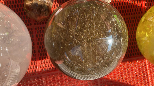 Gold hair rutilated quartz sphere 8